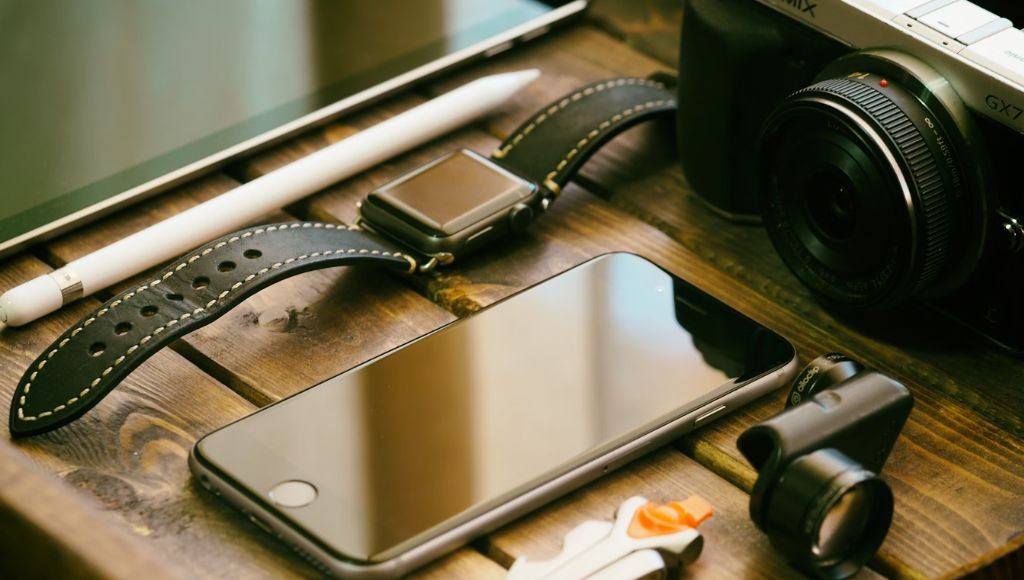 phone, watch and camera accessories sit on a crate