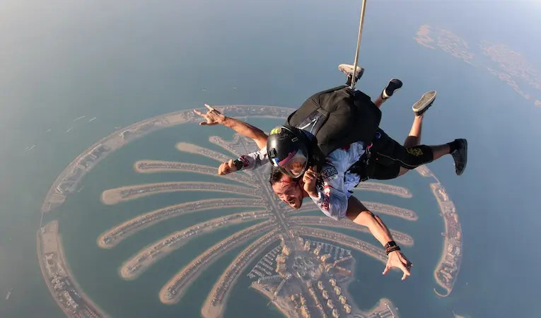 Two skydivers in mid-air, enjoying the thrill of adventure tourism
