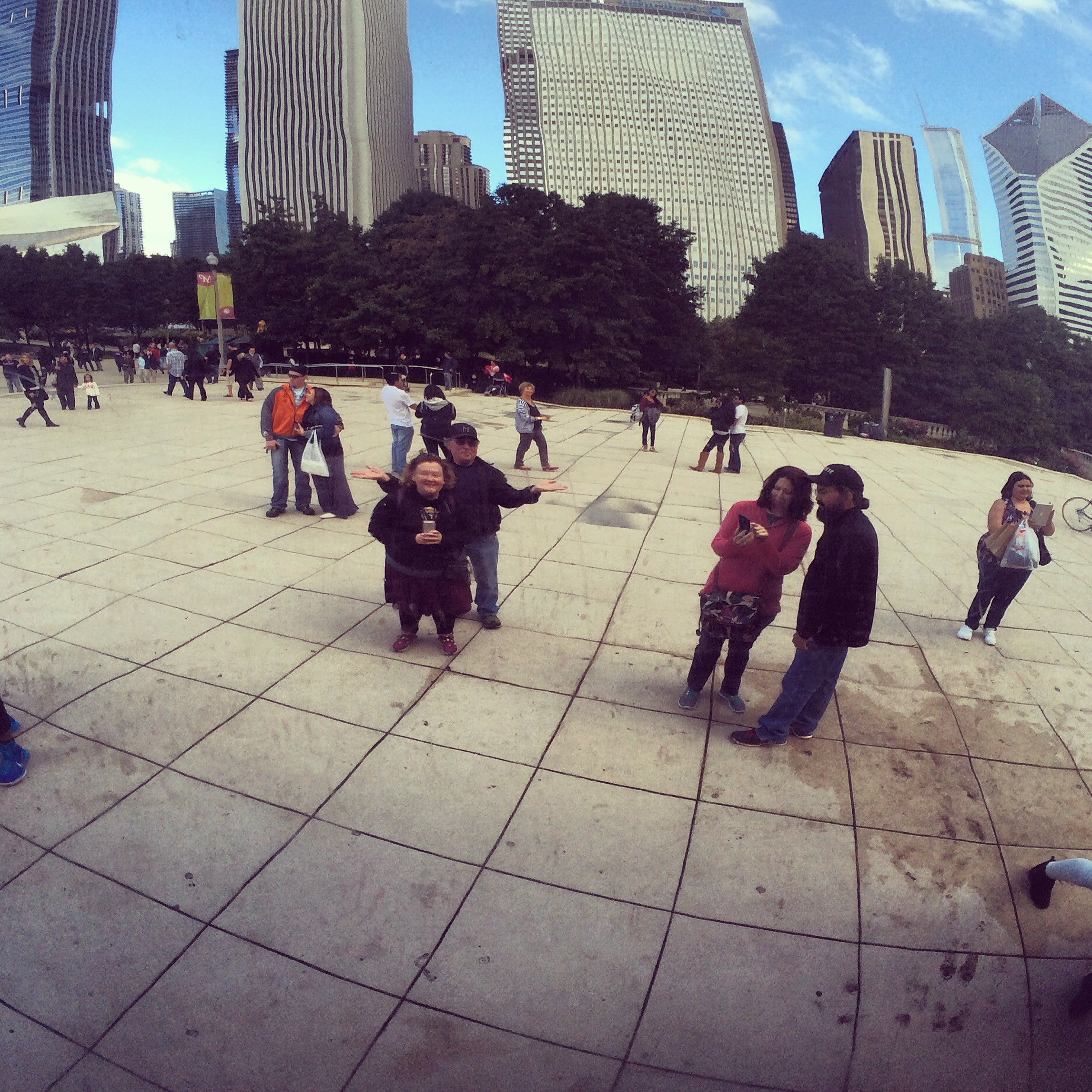 Tourists interacting with the reflective surface of Cloud Gate