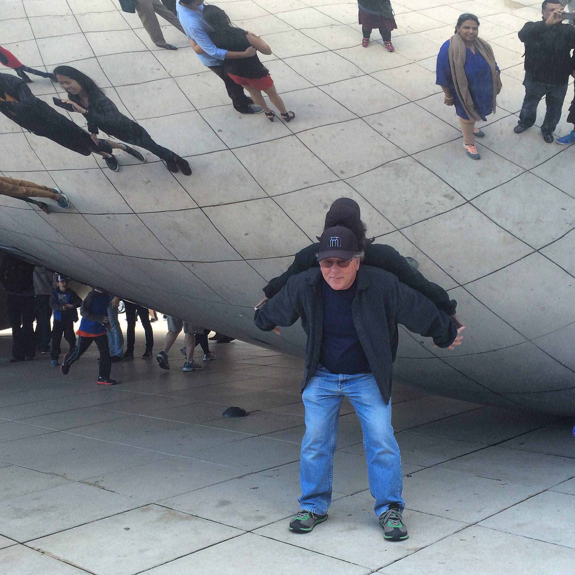 Visitors enjoying the reflections at Cloud Gate