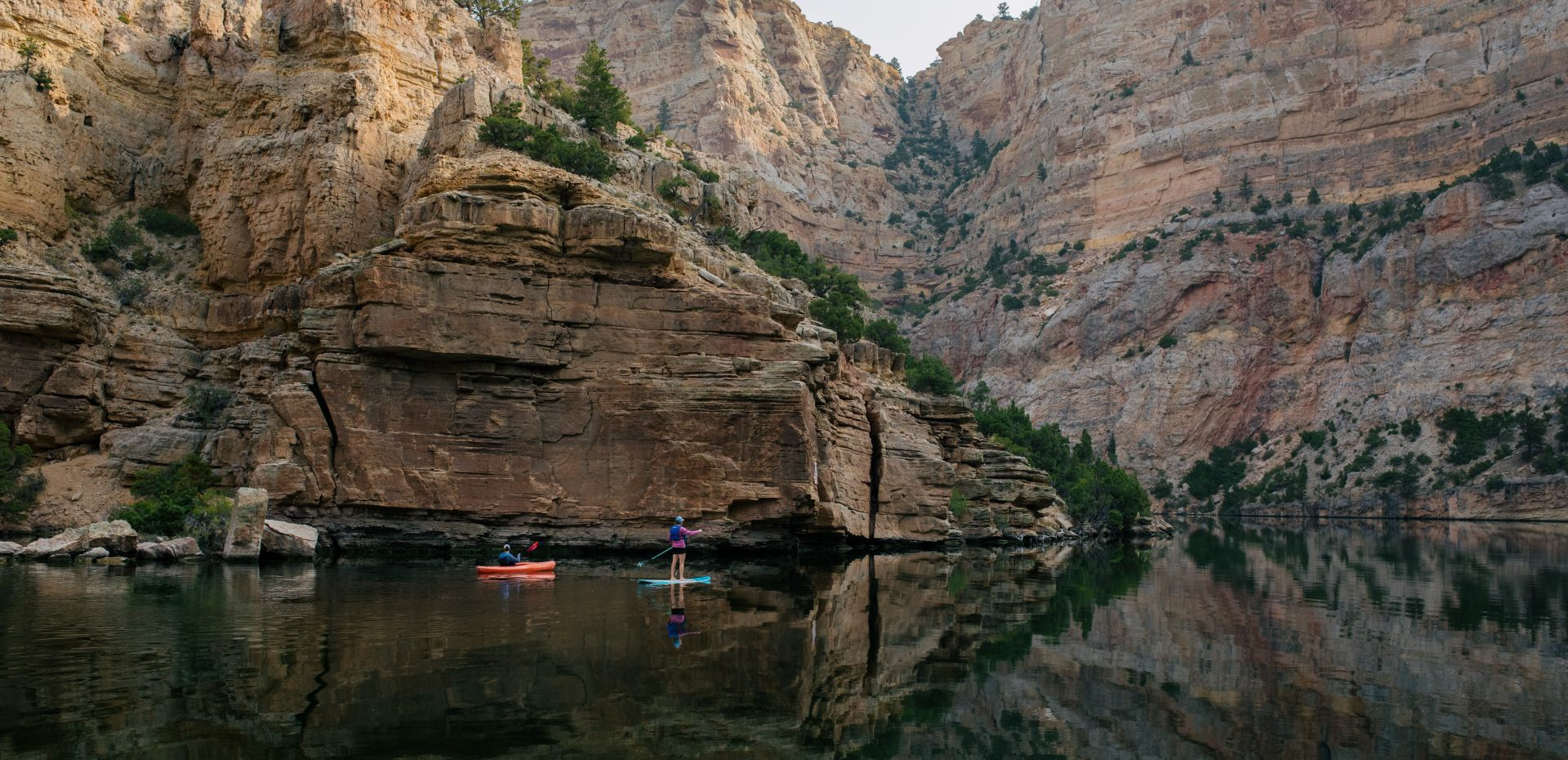 Kayaking Fremont Canyon with towering rock walls and clear blue water