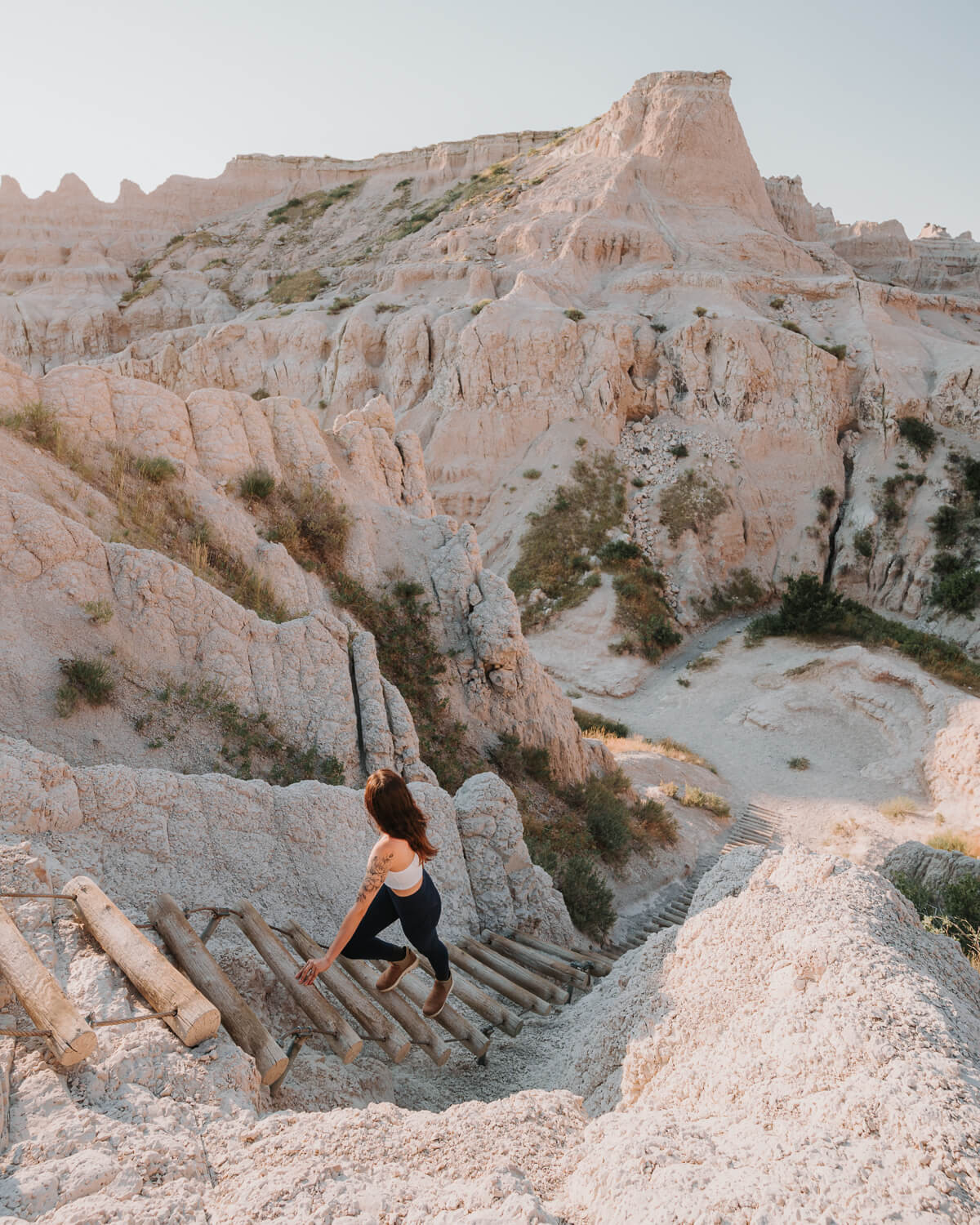 A woman hiking the Notch Trail in Badlands National Park