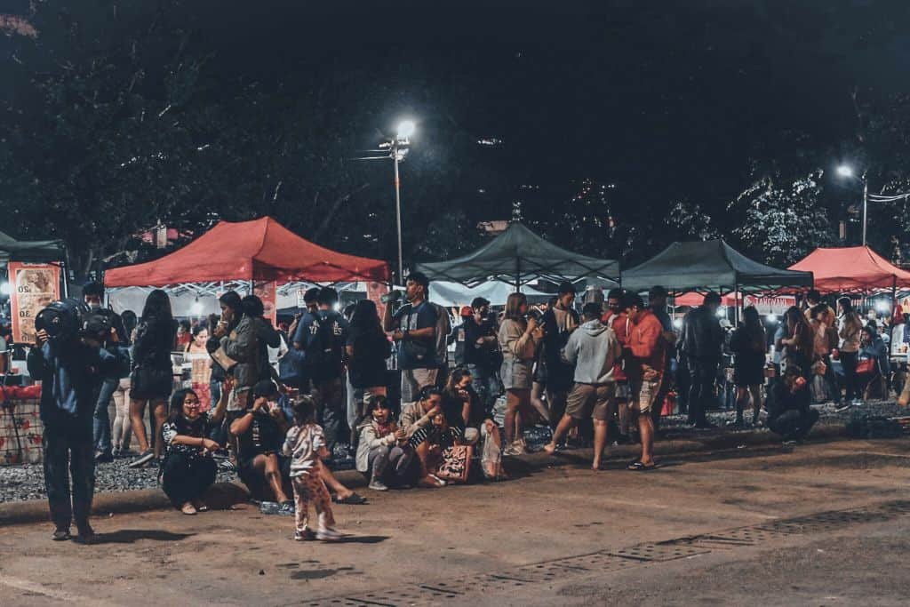 Lively atmosphere of the Baguio Night Market, featuring vibrant stalls and bustling crowds enjoying street food and shopping