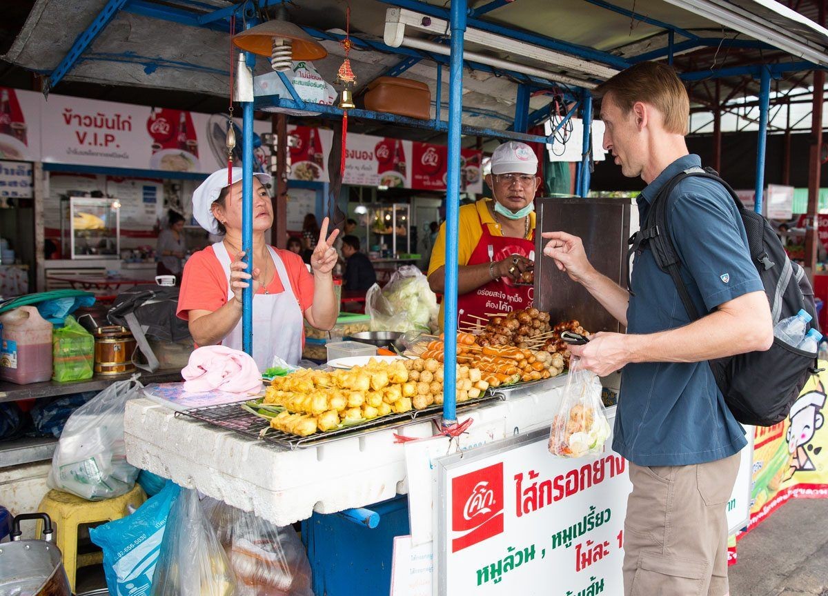 A traveler enjoying street food in Hanoi, Vietnam, experiencing the local culture