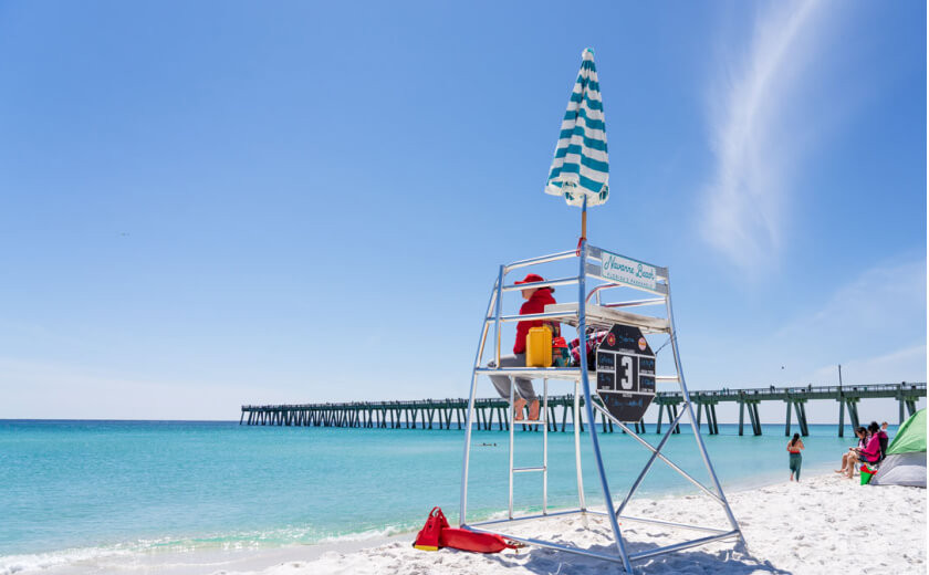 Sign indicating beach rules on Navarre Beach, Florida, ensuring safety and cleanliness