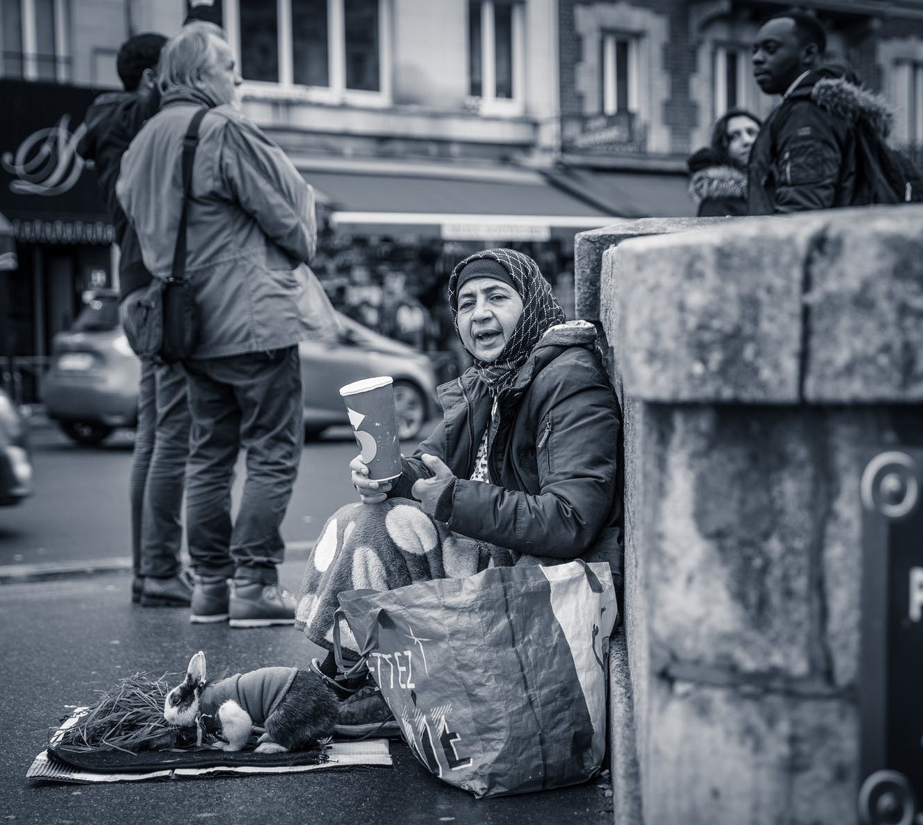 A person handing out food to a child in need, illustrating an alternative to giving money directly.
