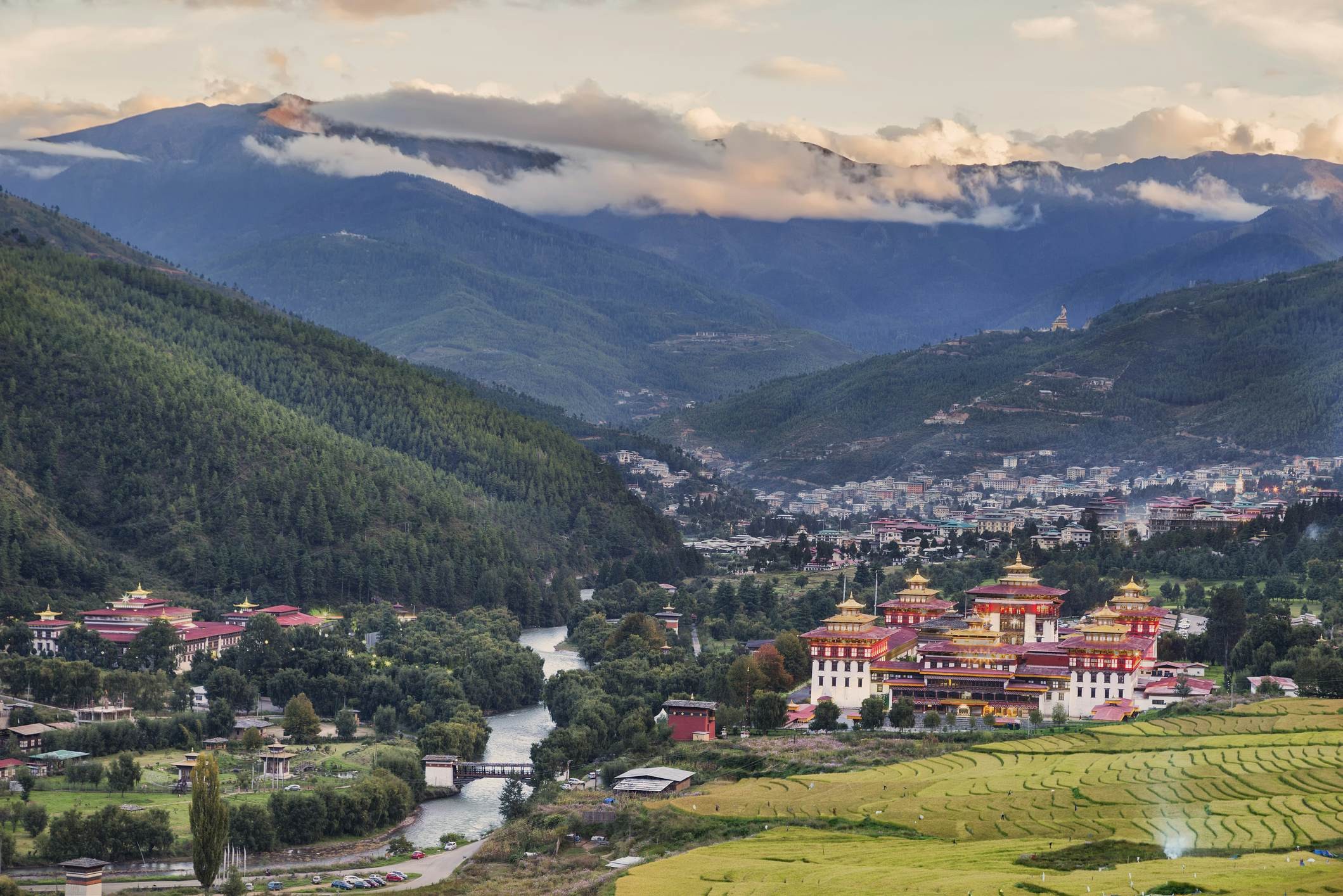 A view over Thimphu, with the Trashi Chho Dzong towering beside the river.