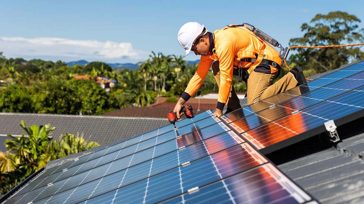 A man installs solar panels on a roof. Efforts like this can provide evidence of a company