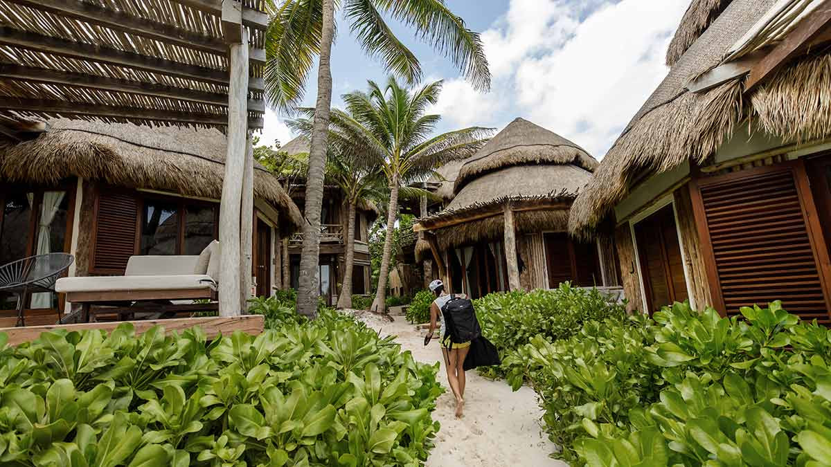 Tourists relax in a pool at a resort in Phu Quoc. Eco-resorts like this often greenwash tourists.