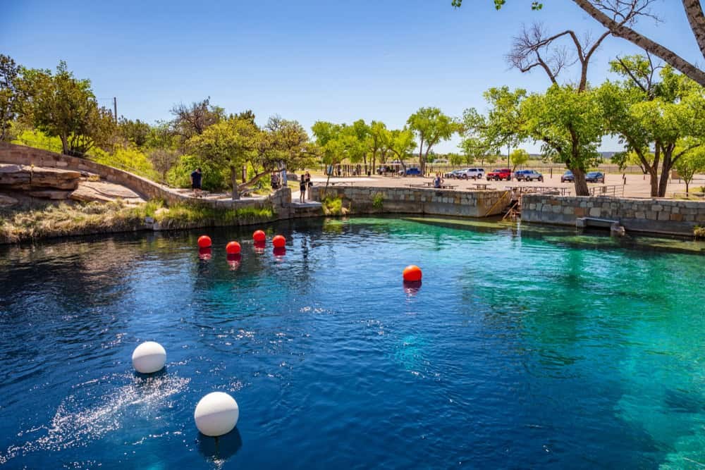 Blue Hole of Santa Rosa - A clear blue water hole surrounded by rocks and land