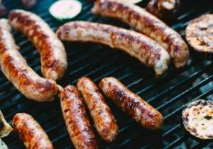 A close-up of Sheboygan brats served on a hard roll