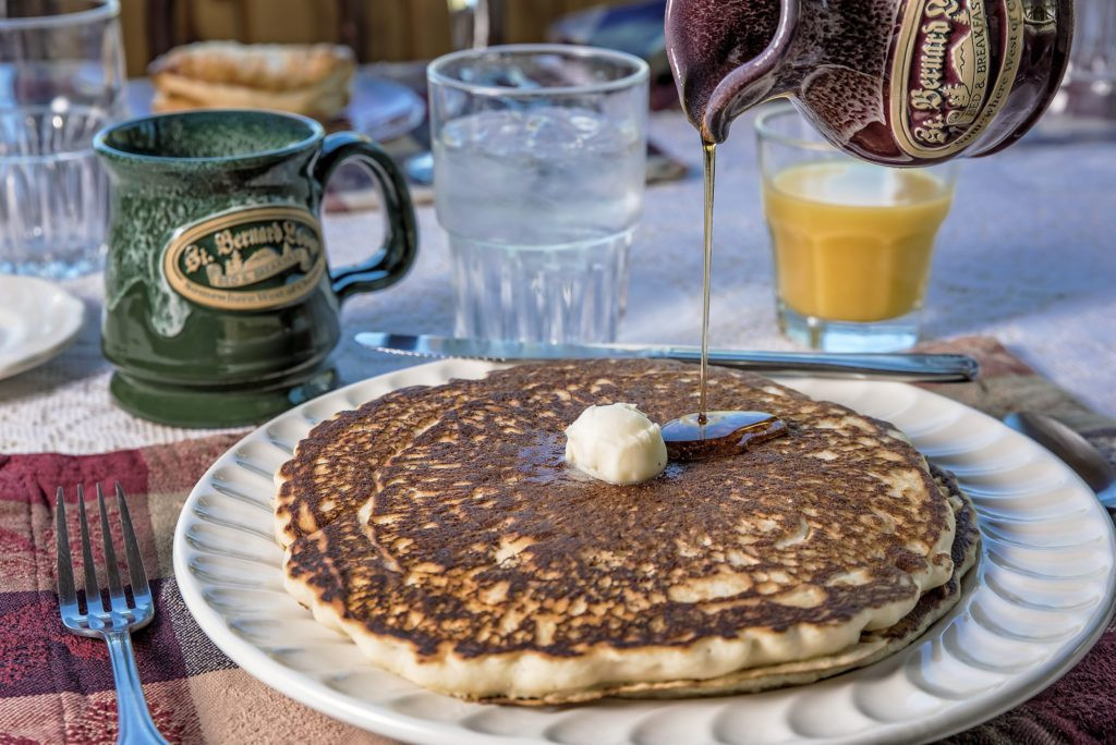 A stack of pancakes, highlighting the breakfast included at St. Bernard Lodge