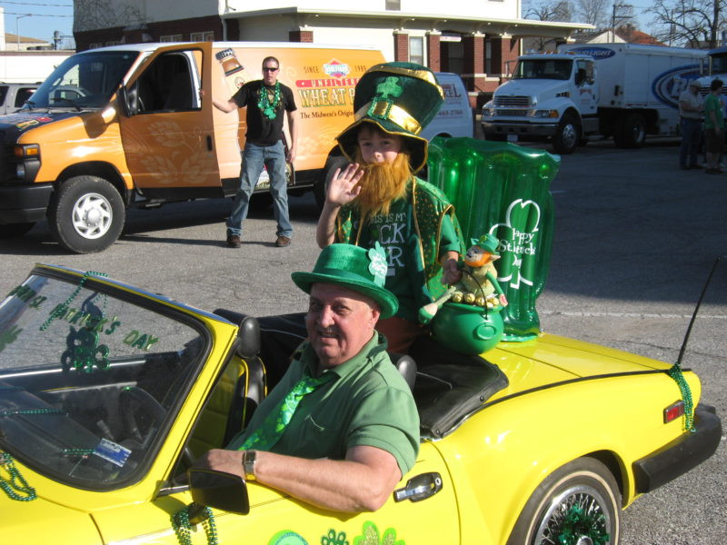 A man and child dressed up in green for St Patrick