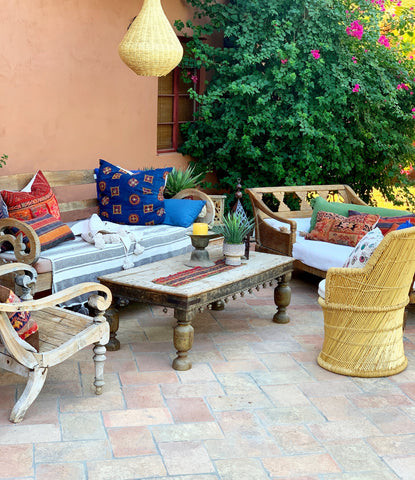 Poolside lounger featuring a ten-foot-long daybed made from architectural salvage in India, providing a unique and comfortable relaxation spot, part of the India World Traveler Collection