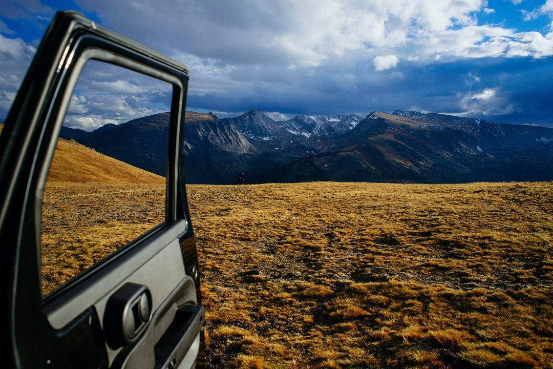 Car door open to scenic mountainscape
