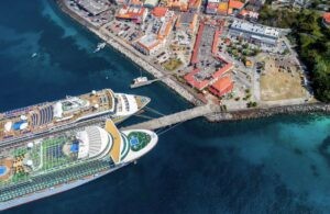 Two cruise ships docked in a Caribbean harbor, showcasing the potential for passport-free travel