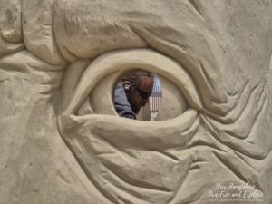 Sand Sculpting Classic participants working at night