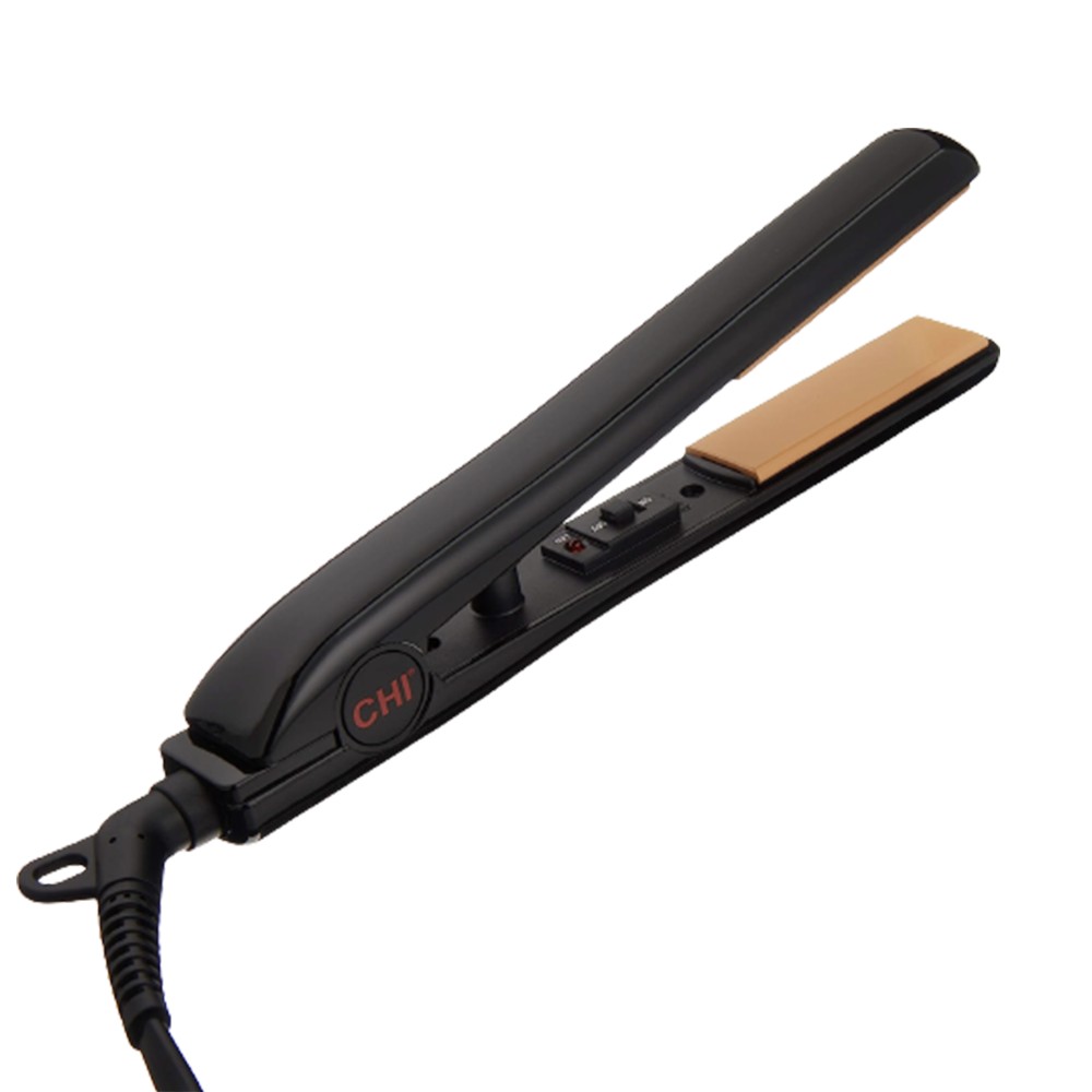 Woman using a travel straightener in a hotel room, smiling