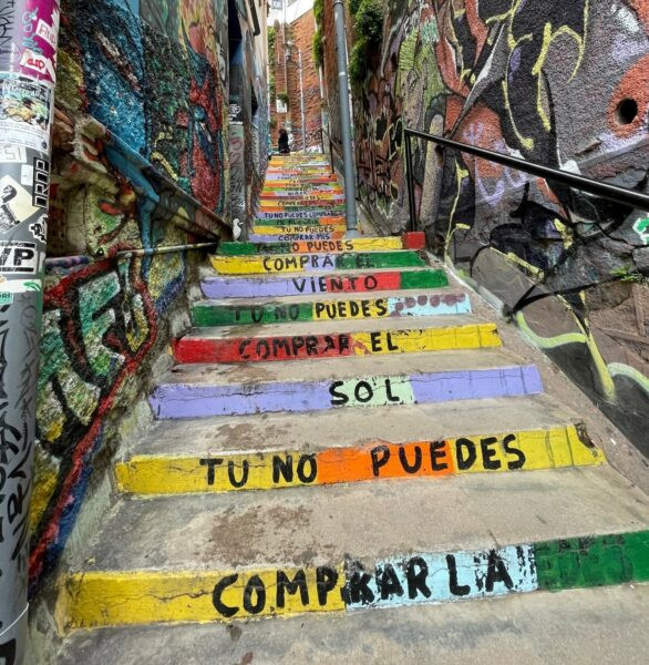 Valparaiso street art featuring stairs with colorful designs, showcasing the city's artistic flair and the dynamic murals found throughout the urban landscape.