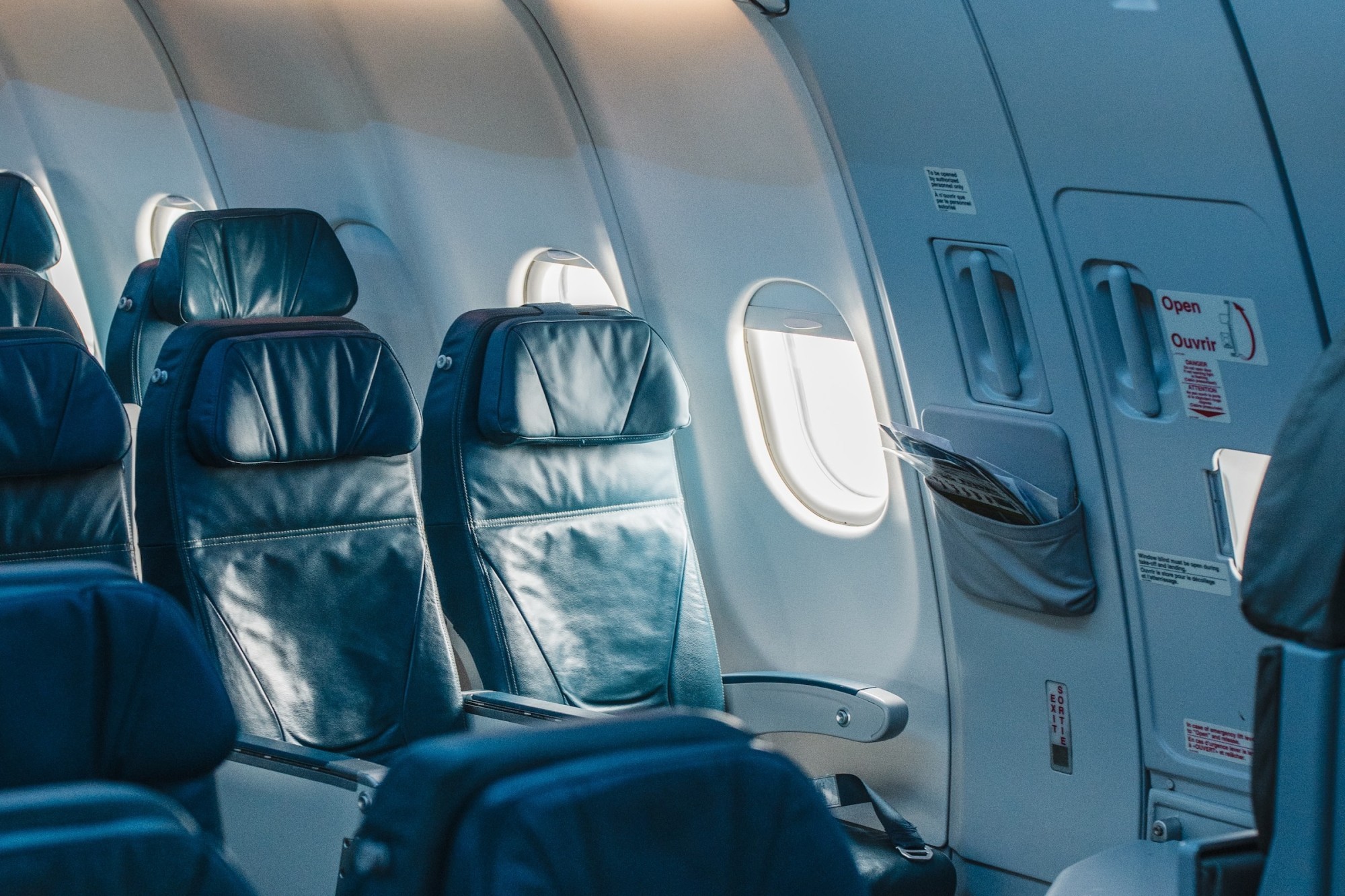 Empty business-class seats on an airliner, perfect for travel agents planning luxurious itineraries for clients