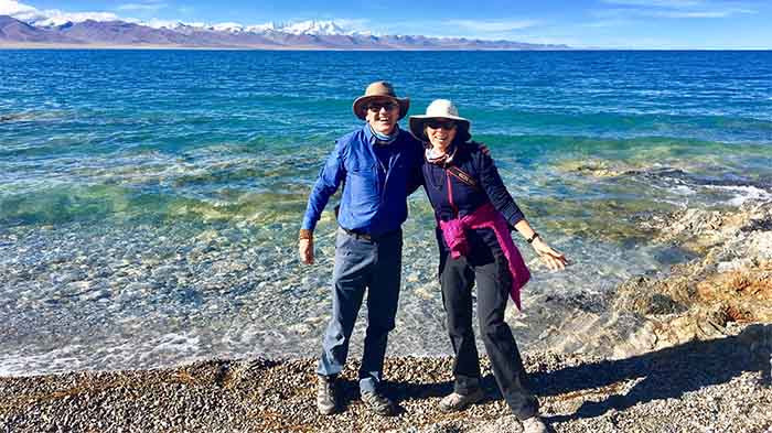 The serene beauty of Namtso Lake, reflecting the clear sky and surrounding mountains, inviting visitors to experience its tranquility