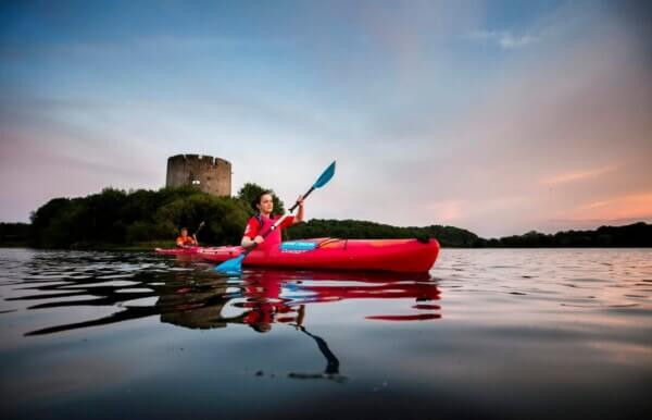 a woman kayaking in a lake Cavan: Ireland