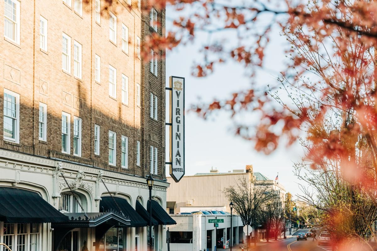 Exterior of the Virginian Hotel in Lynchburg, Virginia, featuring its classic architecture and well-maintained facade on a bright day.