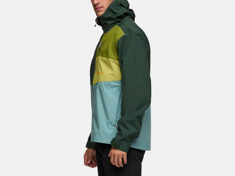 Man wearing green and blue rain jacket