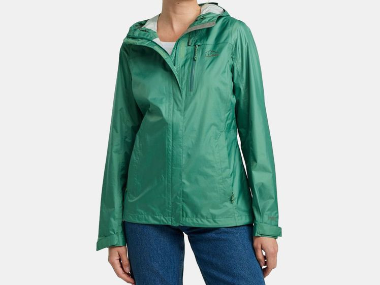Woman wearing green, short rain jacket