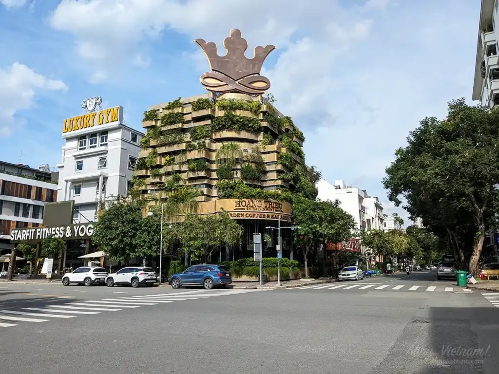 Intersection in Phu My Hung, District 7, Ho Chi Minh City, showing a coffee shop and karaoke place across the street