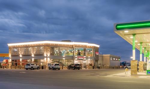 Coffee Cup Travel Plaza exterior at night with illuminated signage, promoting a welcoming atmosphere for travelers