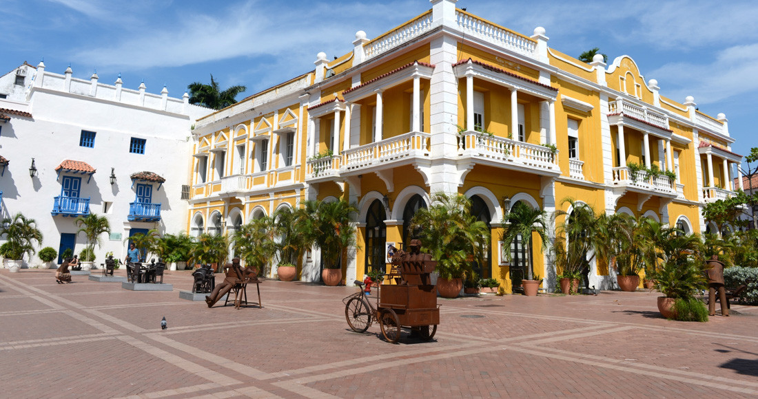 A vibrant street scene in Cartagena, Colombia, showcasing colorful colonial architecture