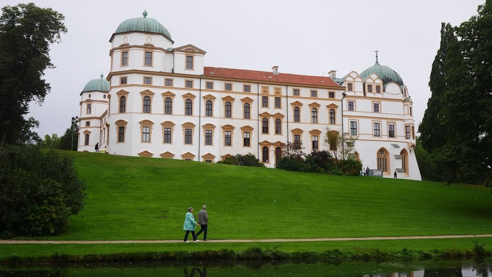 Couple strolling by the Celle Castle and Gardens 
