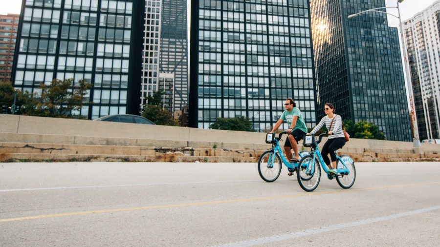 Couple biking on Divvy bikes in Chicago
