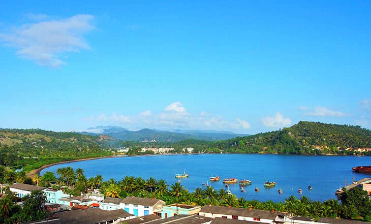 A view of Baracoa, Cuba, showcasing its colonial architecture and the El Yunque mountain in the background
