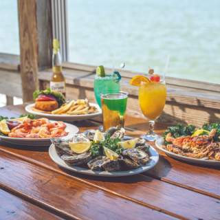 Seafood and colorful drinks at a waterfront restaurant in Newport News