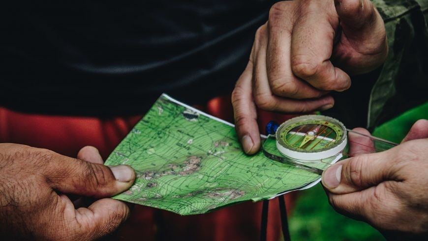 a travel guide pointing at a map, highlighting the challenges