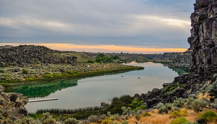 Rock climbers scaling the basalt cliffs at Dierkes Lake near Twin Falls