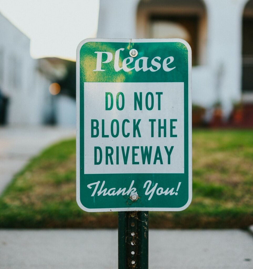 RV parked in a driveway with a &quot;No Parking&quot; sign