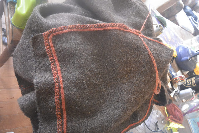 Crossed blanket stitch hem on cloak