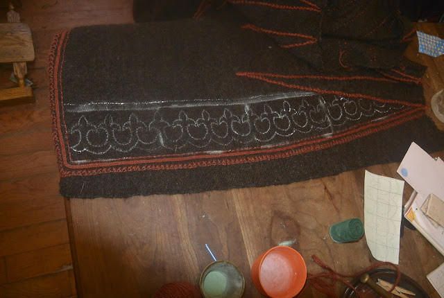 Marking the fronts of the cloak with white gouache