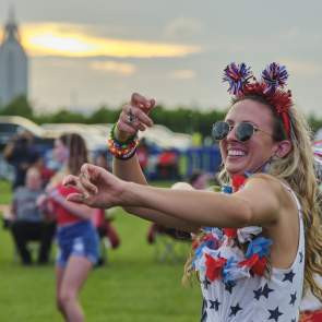 Woman dancing in Gulf State Park Alabama, showing the summer vibes