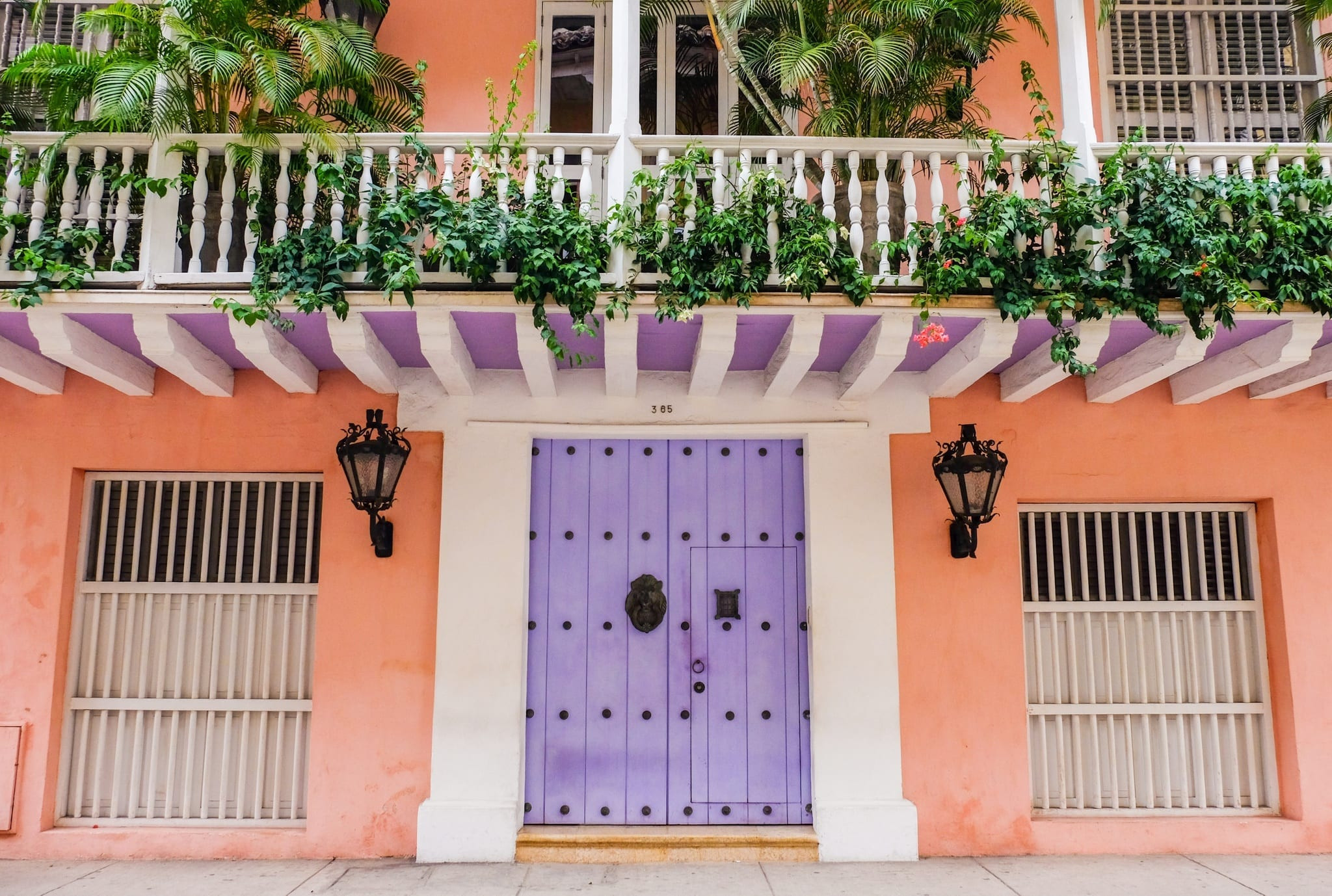 A vibrant street in Cartagena, Colombia, showcasing colorful colonial architecture and bustling street life