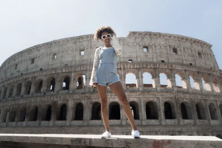 Smiling tourist in front of the Colosseum in Rome