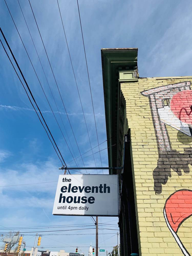 Sign for Eleventh House Coffee offering a unique coffee and tavern experience.
