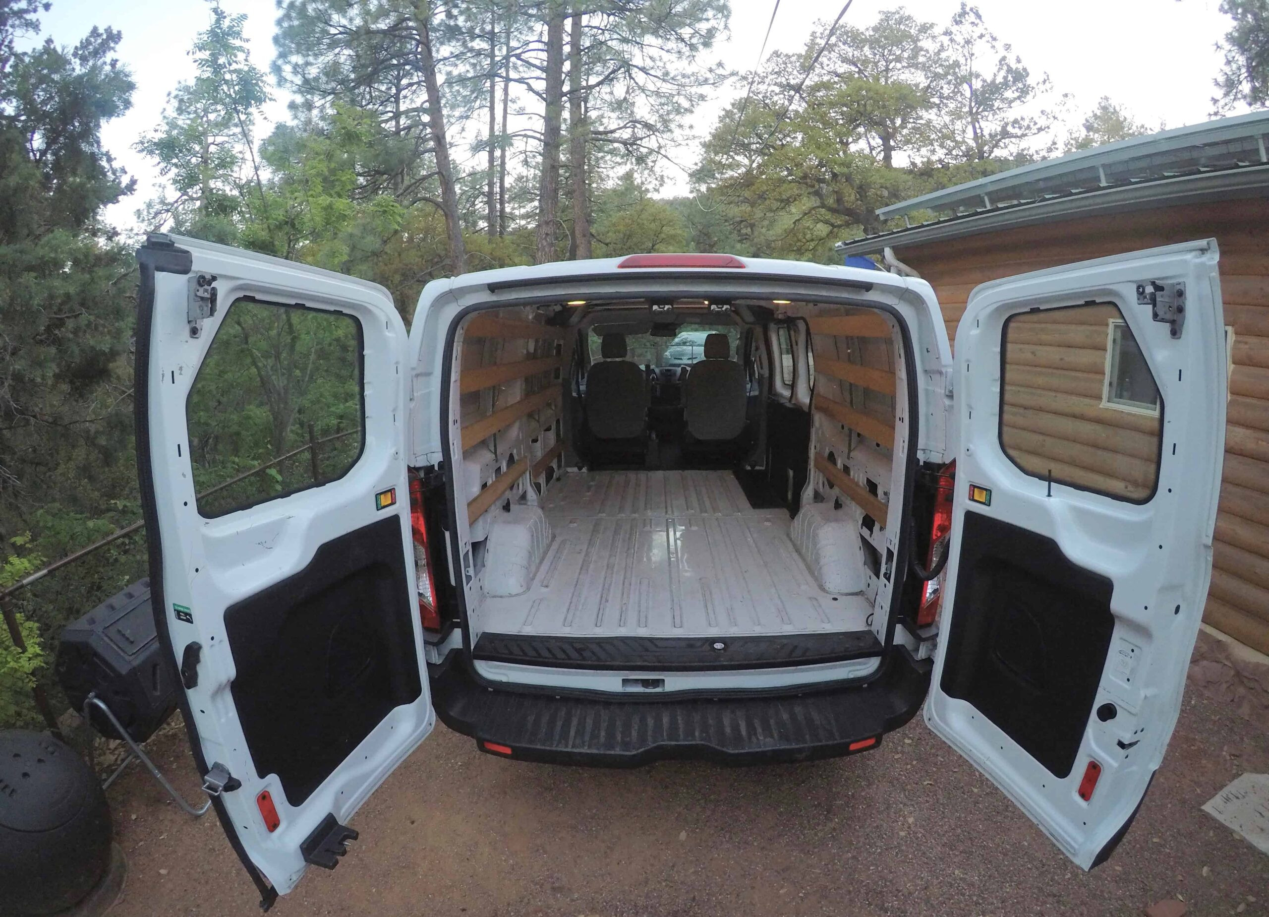 Applying sound deadening material to van walls for noise reduction