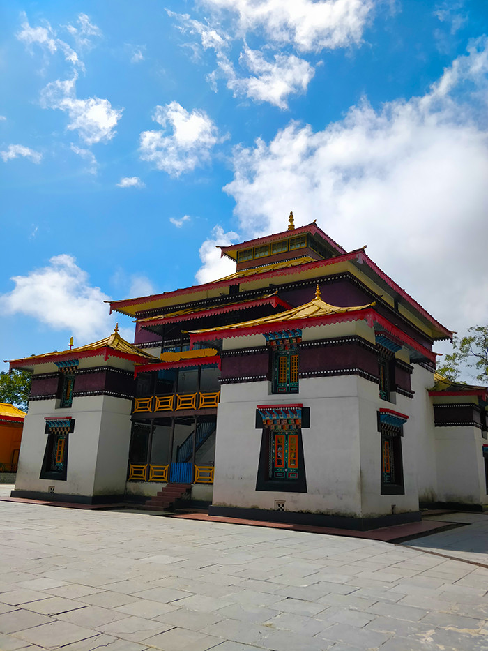 Enchey Monastery Alt Text: A picturesque view of Enchey Monastery, a significant Buddhist monastery in Gangtok, Sikkim, showcasing its traditional architecture and serene surroundings, attracting culture enthusiasts.