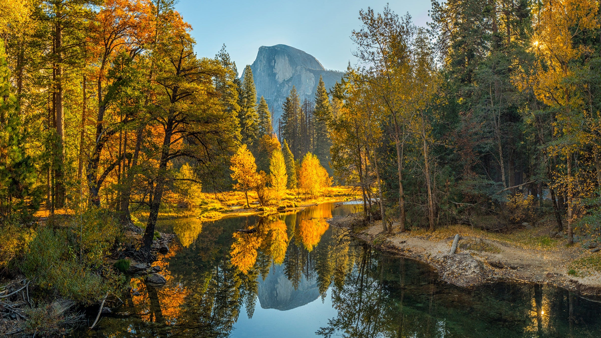 Half Dome reflected in the Merced River on a bluebird day