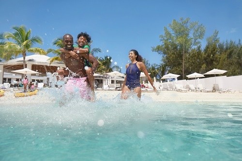 family playing in the waters in the bahamas