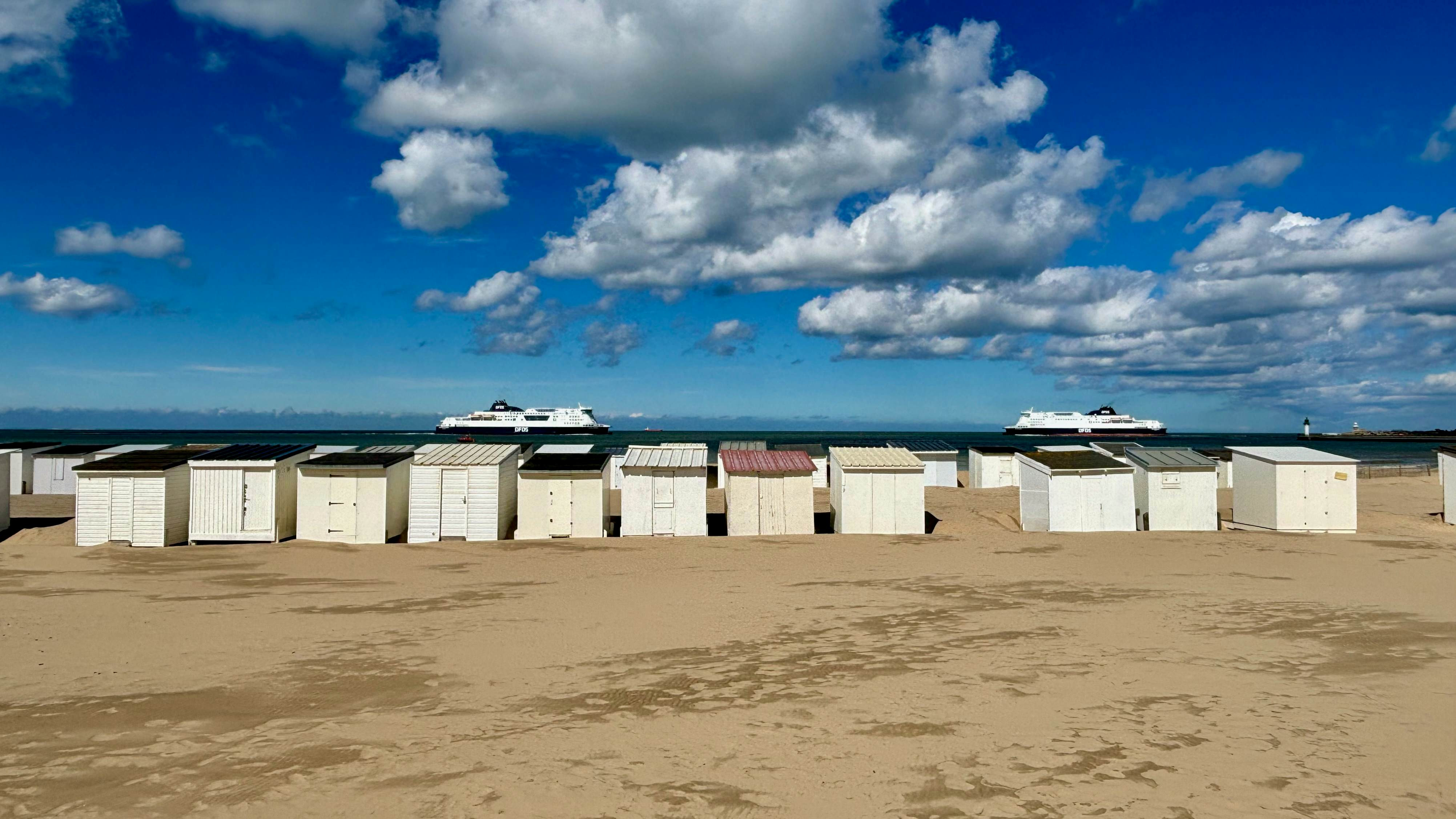 Ancestral beach huts line the golden sand of Calais beach, offering a nostalgic glimpse into the town's coastal heritage